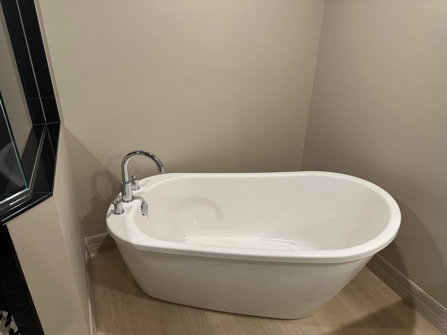Freestanding soaking tub in the remodeled primary bath at the Jasmine Bay Towers condo in Estero, Florida