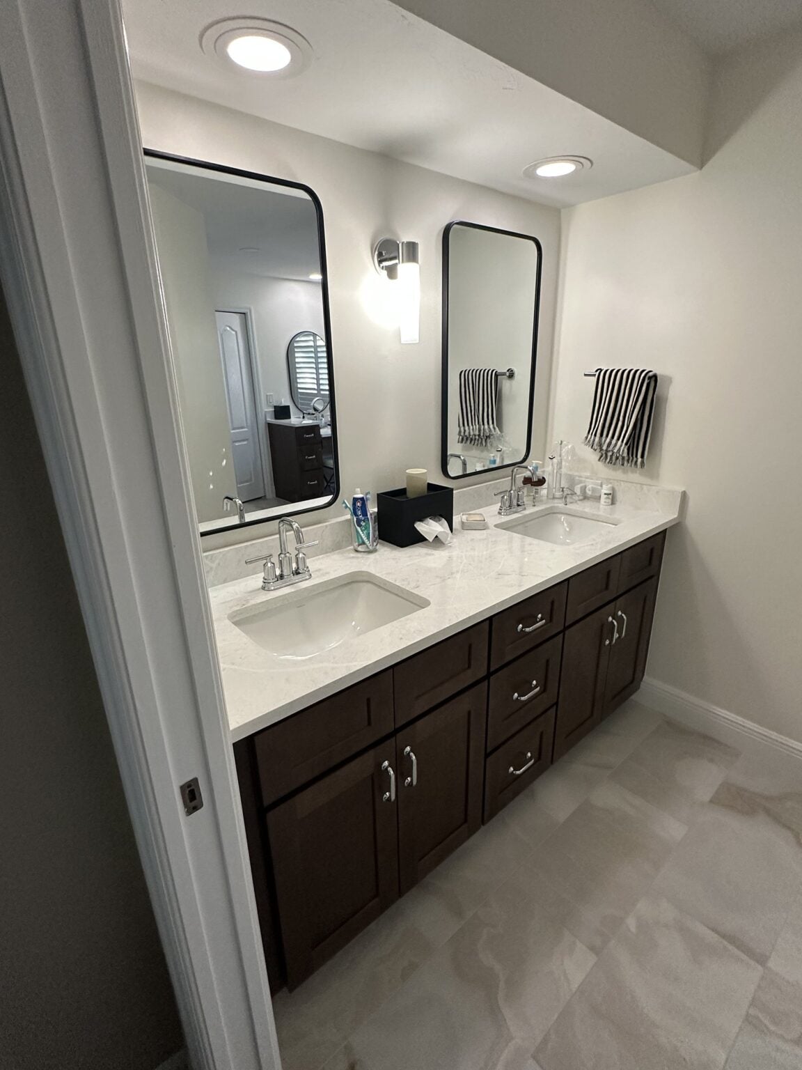 Remodeled bathroom with a dark wood double vanity