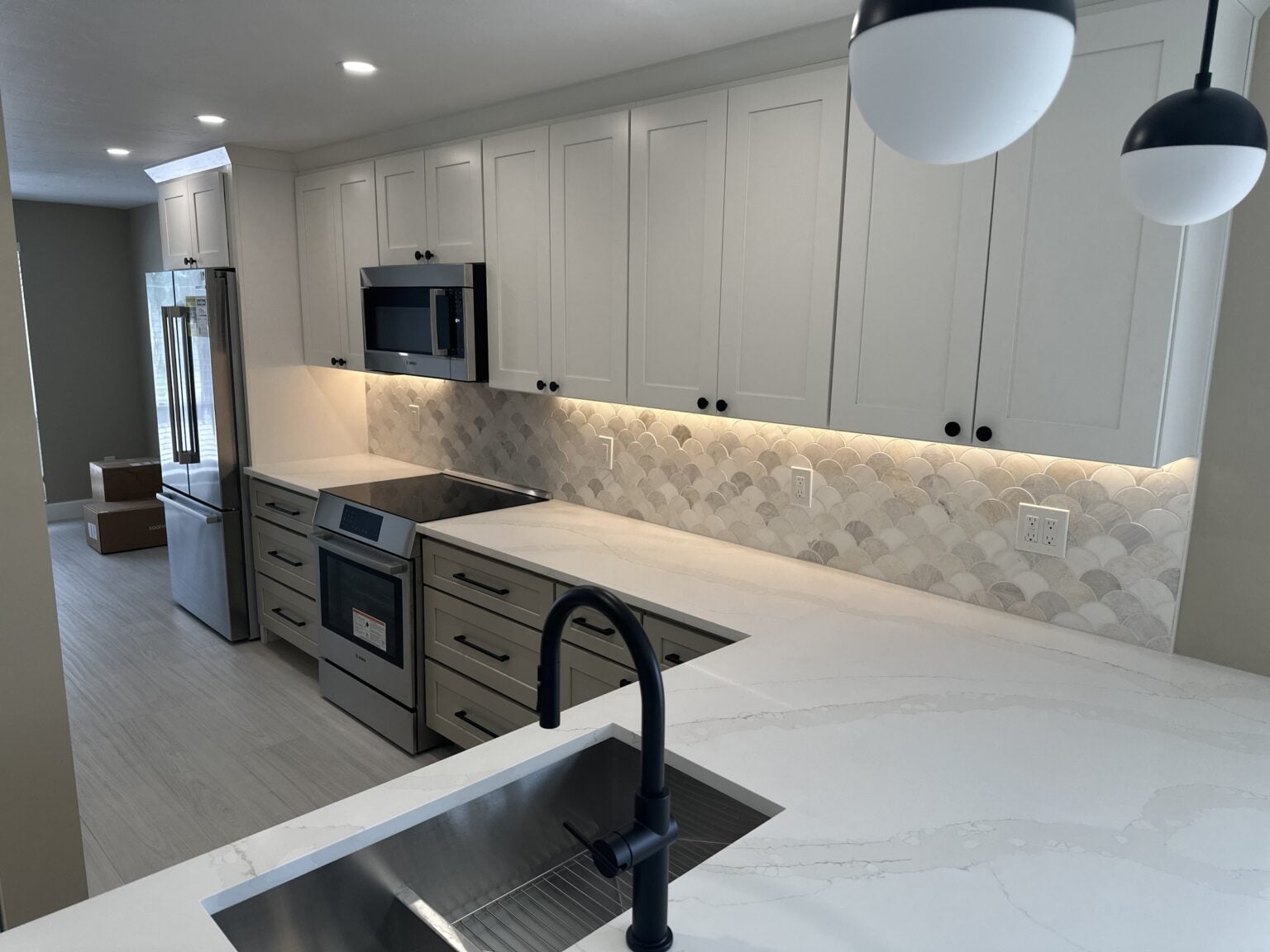 Remodeled kitchen with white cabinets and a quartz island in Bonita Springs, Florida