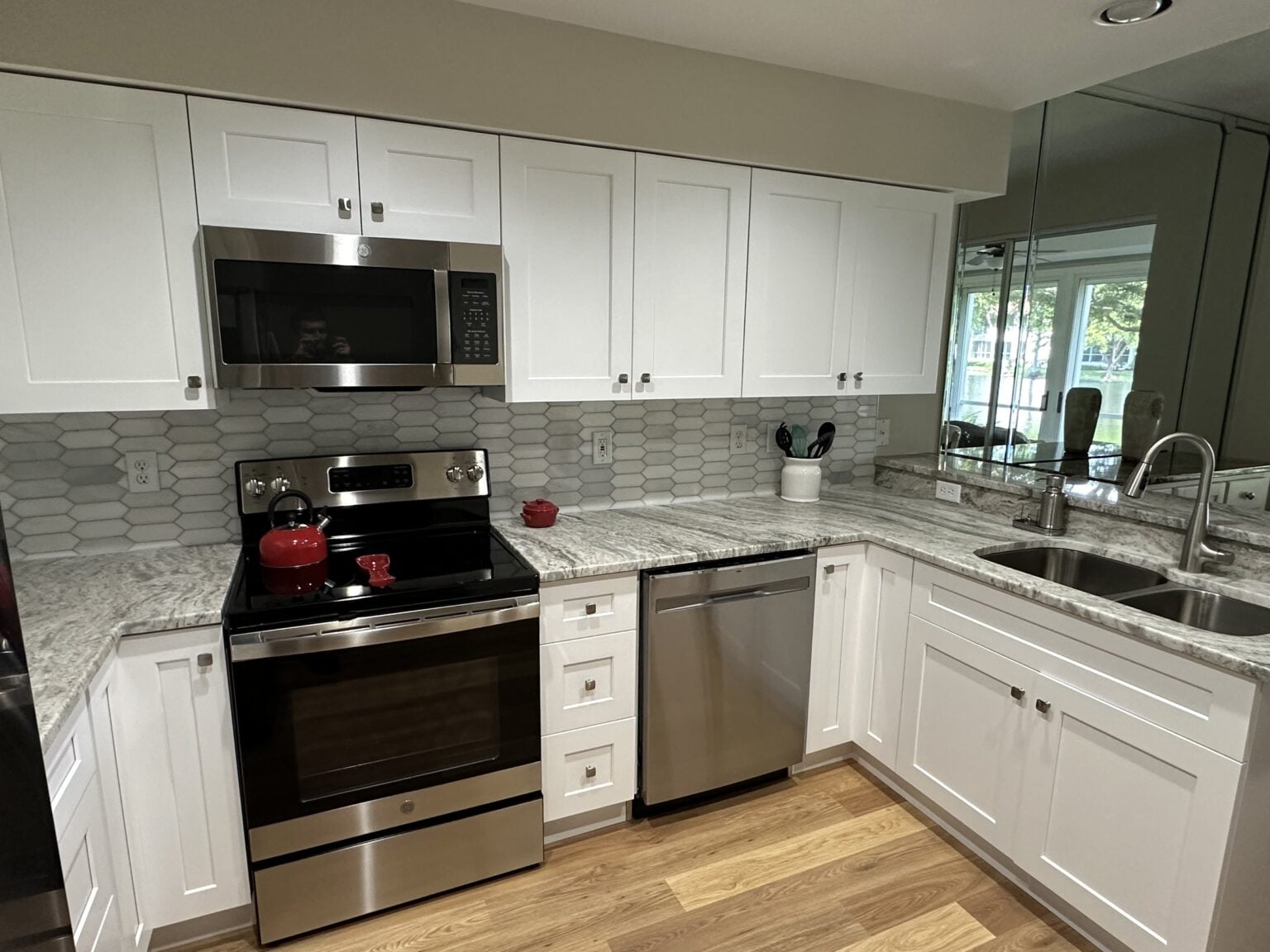 Whole home interior remodel with white cabinetry and wood flooring